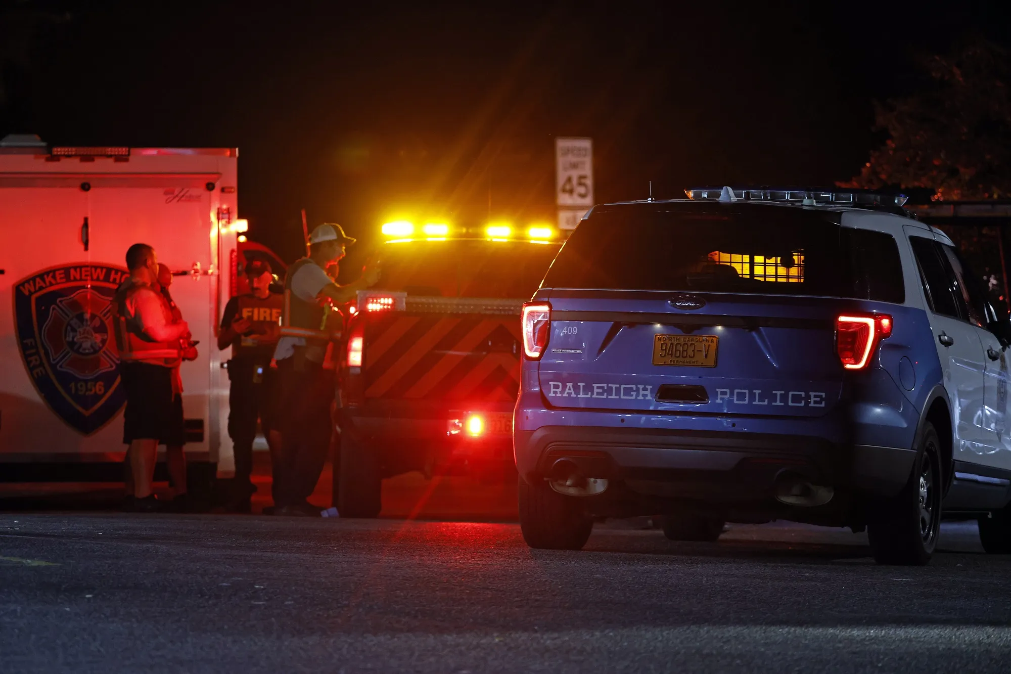 Law enforcement personnel gather at a command post at the intersection of Forestville and Old Milburnie Rd in eastern Wake County, N.C., on Oct. 13.