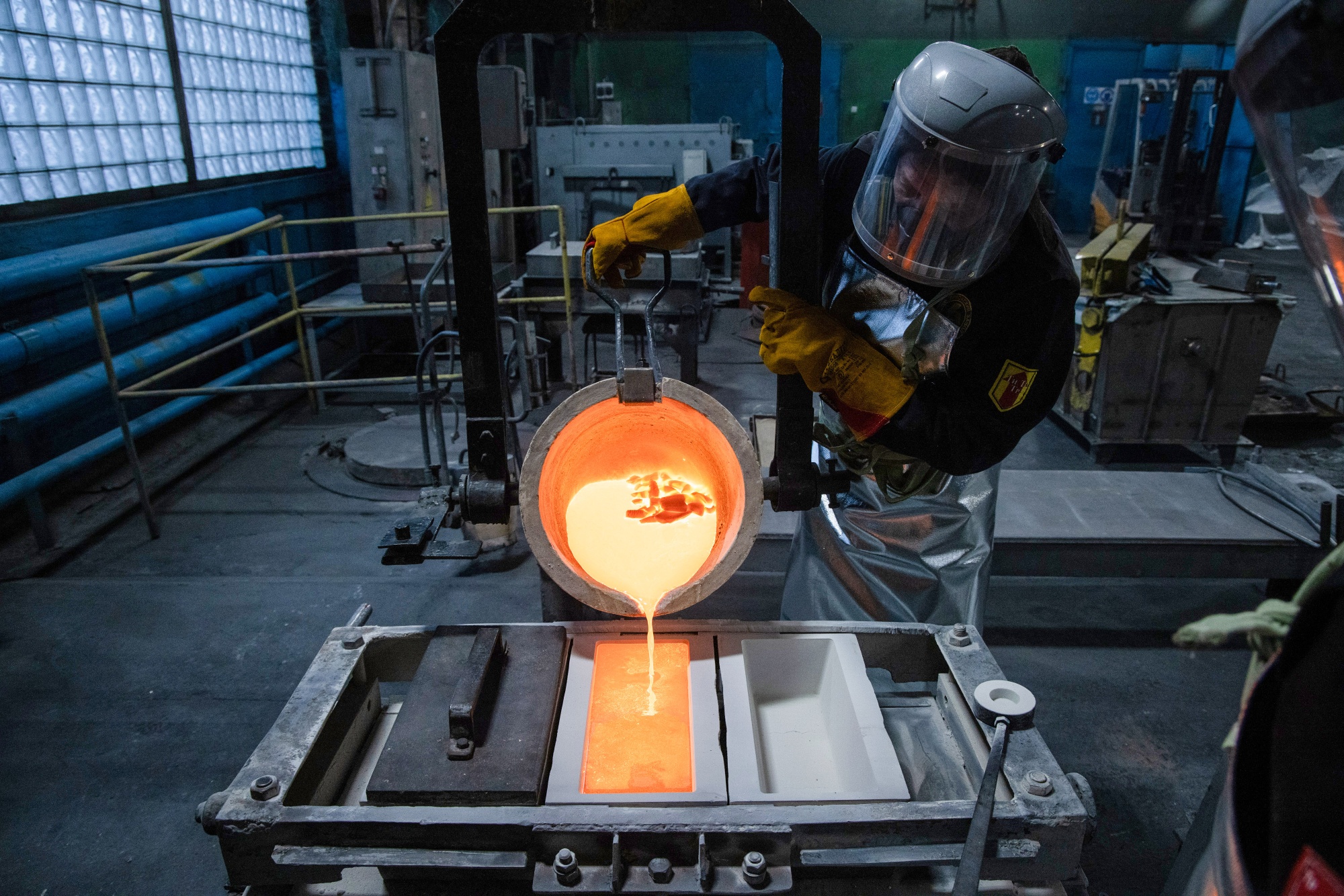 A worker pours molten silver into a mold.&nbsp;Output under categories like “metal goods”&nbsp;jumped by as much as a third compared to 2022.&nbsp;