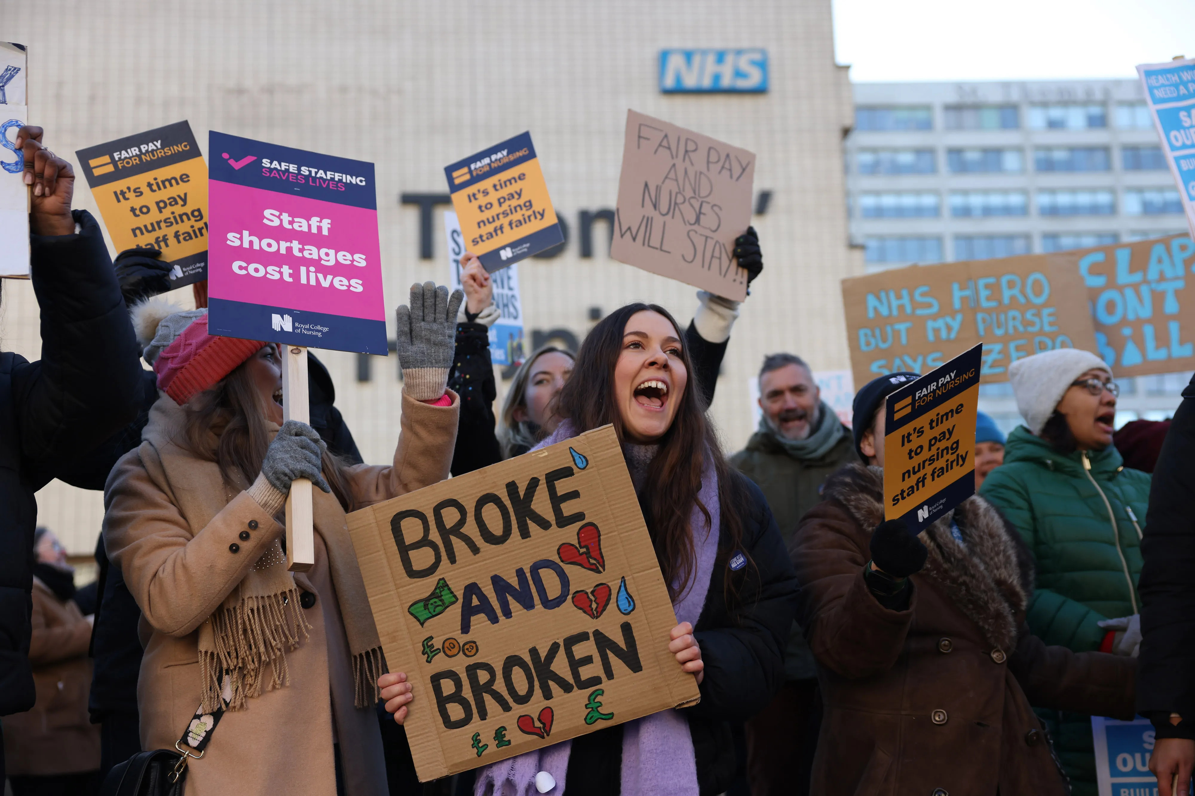 Demonstrators hold placards on a picket line during a strike by NHS nursing staff outside St. Thomas' Hospital in London, on Dec. 15.