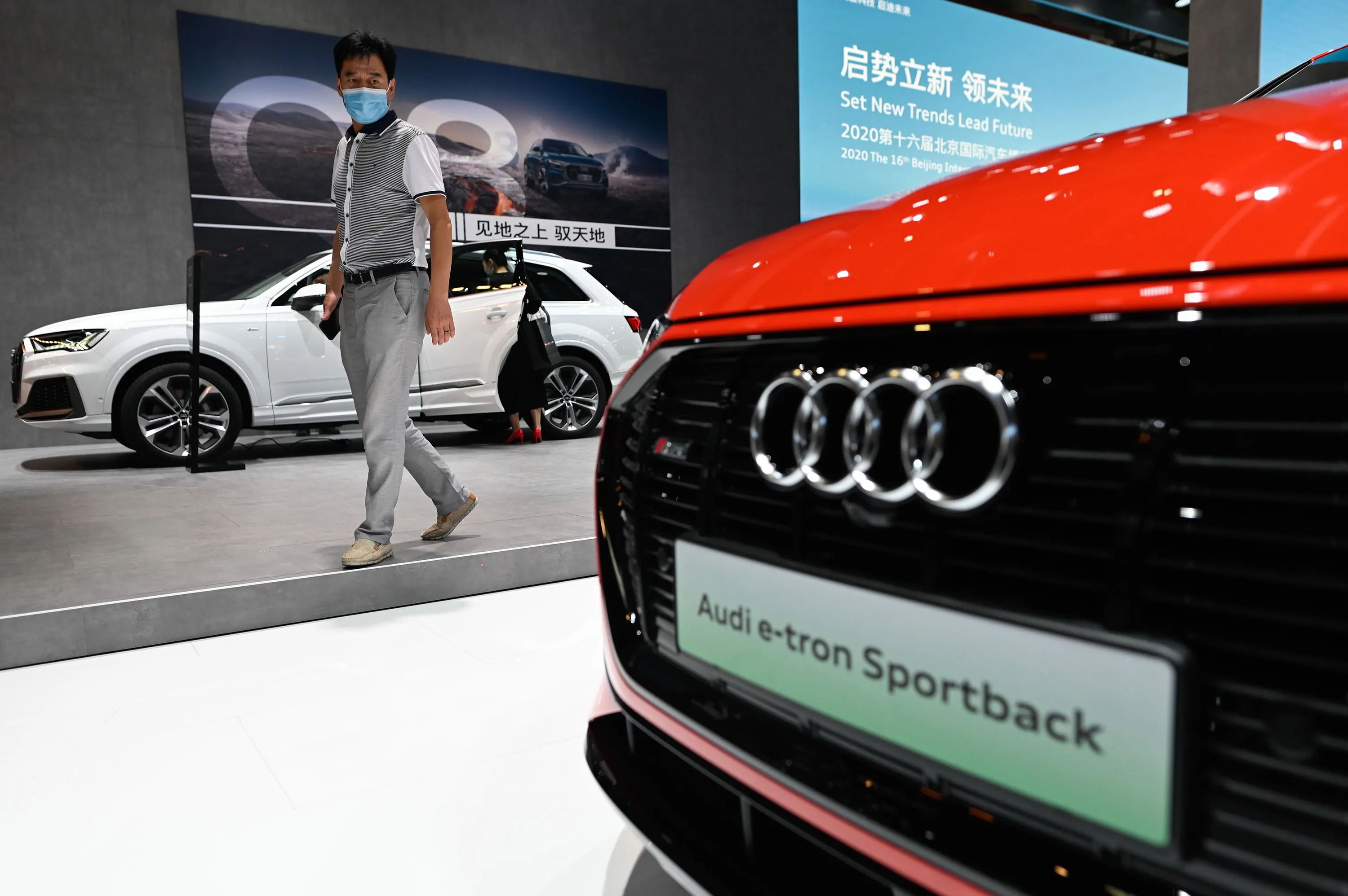 A visitor looks at an Audi e-trion car at the Beijing Auto Show in Beijing on Sept. 27.