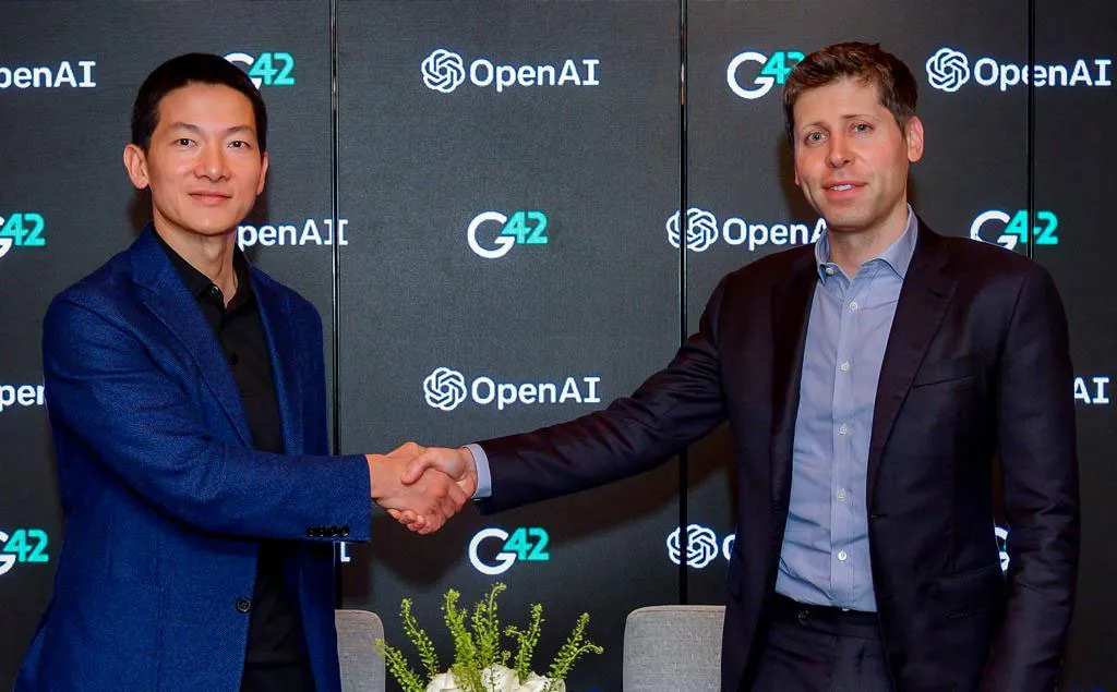 G42 CEO Peng Xiao, left, meets with OpenAI's Sam Altman.