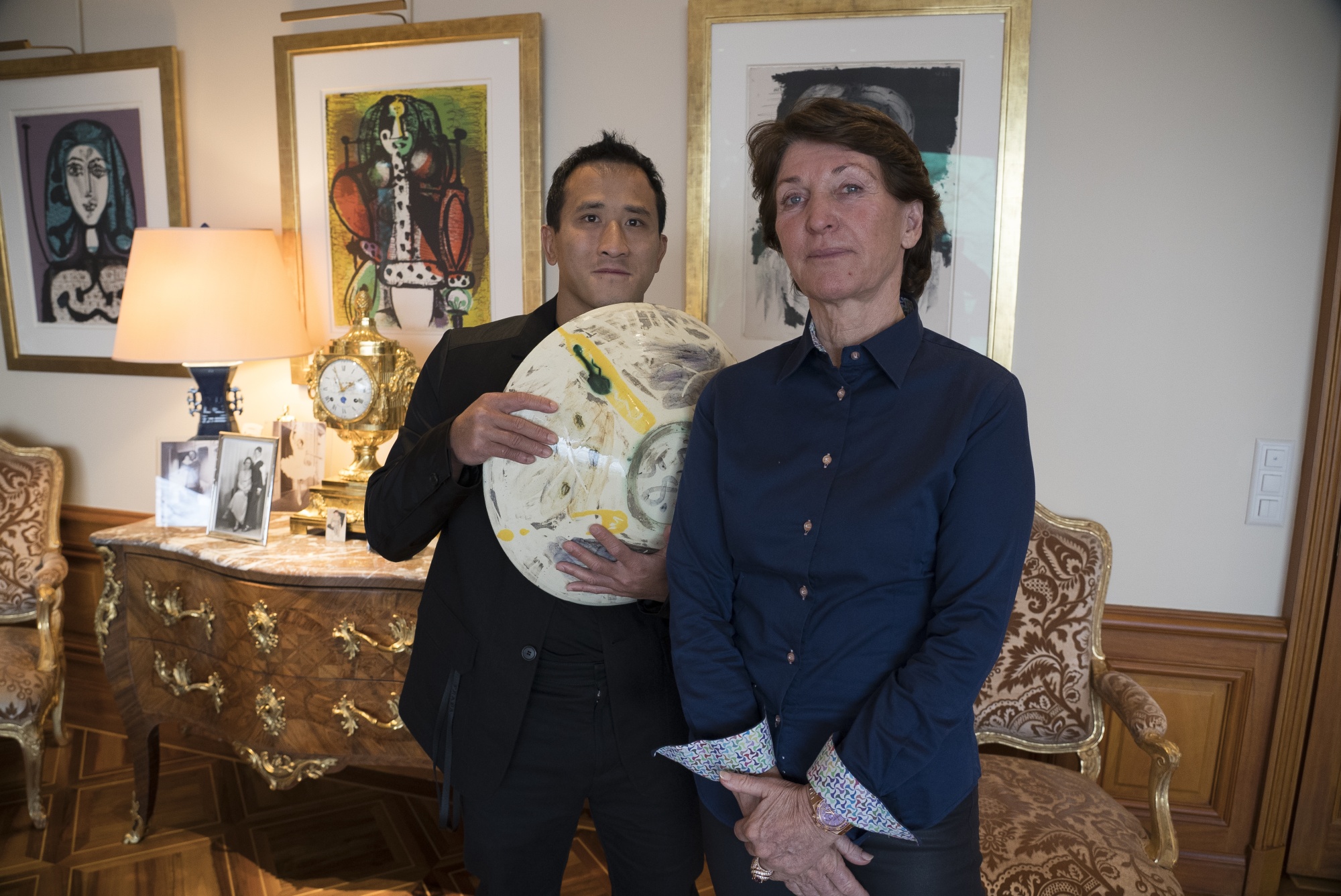 Marina Picasso, right, granddaughter of artist Pablo Picasso, and her son Florian Picasso pose with a ceramic artwork of Pablo Picasso in Cologny near in Geneva on Jan. 25.