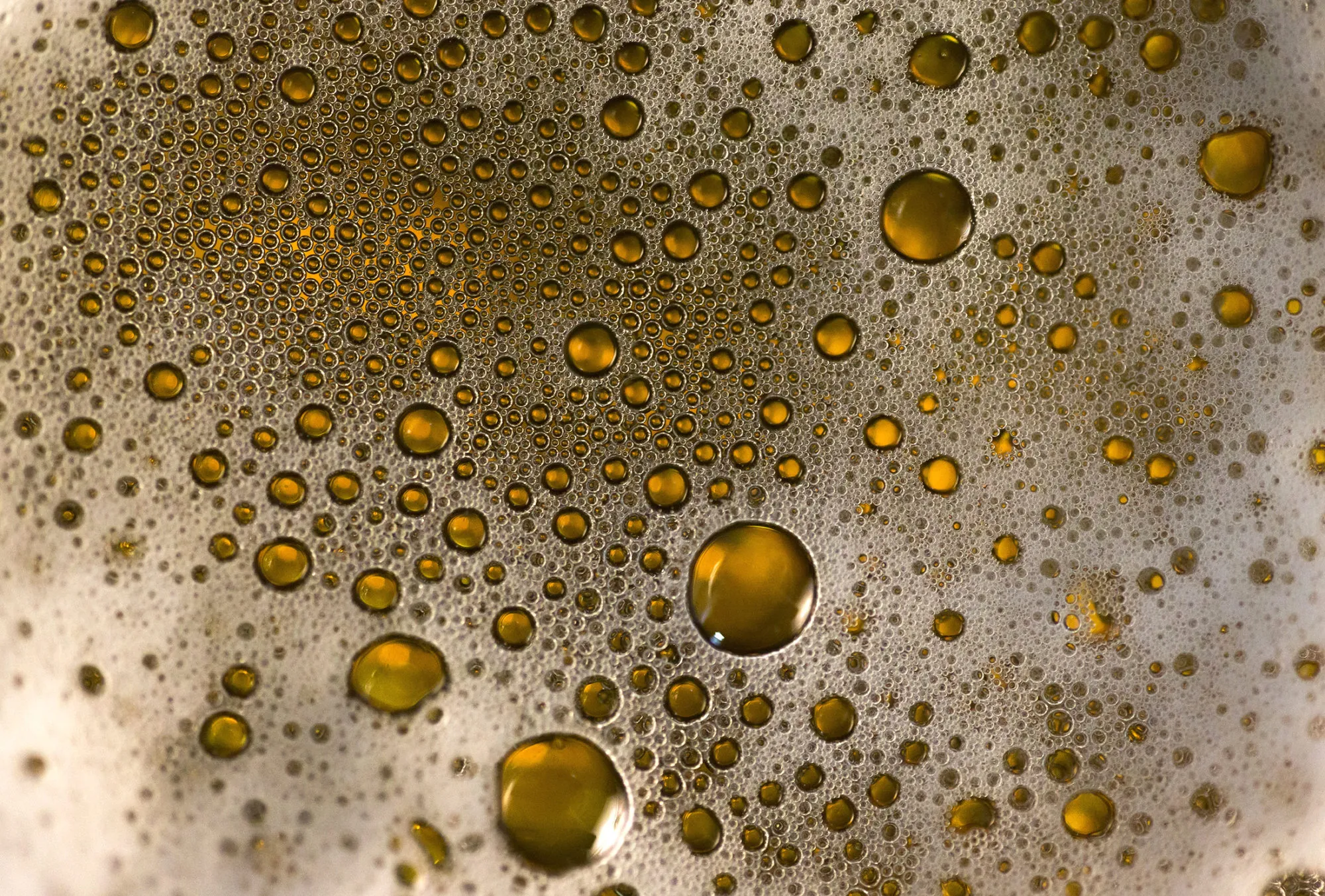 Droplets of Asahi Breweries Ltd.'s Asahi Super Dry beer sits on glass in this arranged photograph in Tokyo, Japan, on Tuesday, Dec. 13, 2016. Asahi agreed to buy SABMiller Plc's eastern European assets including Pilsner Urquell from Anheuser-Busch InBev NV for 7.3 billion euros ($7.8 billion), as the Budweiser maker ties up loose ends after combining the world's two biggest brewers.
