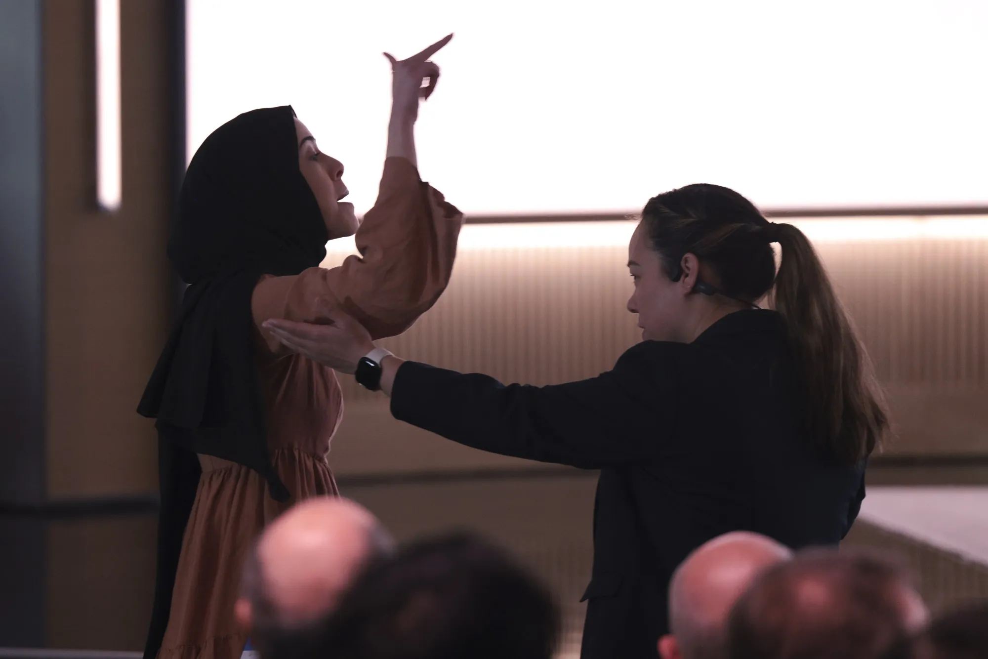 Ibtihal Aboussad is escorted away by security after interrupting Microsoft AI CEO Mustafa Suleyman, not pictured, during a presentation at Microsoft headquarters&nbsp;in Redmond, Washington, on Friday, April 4.