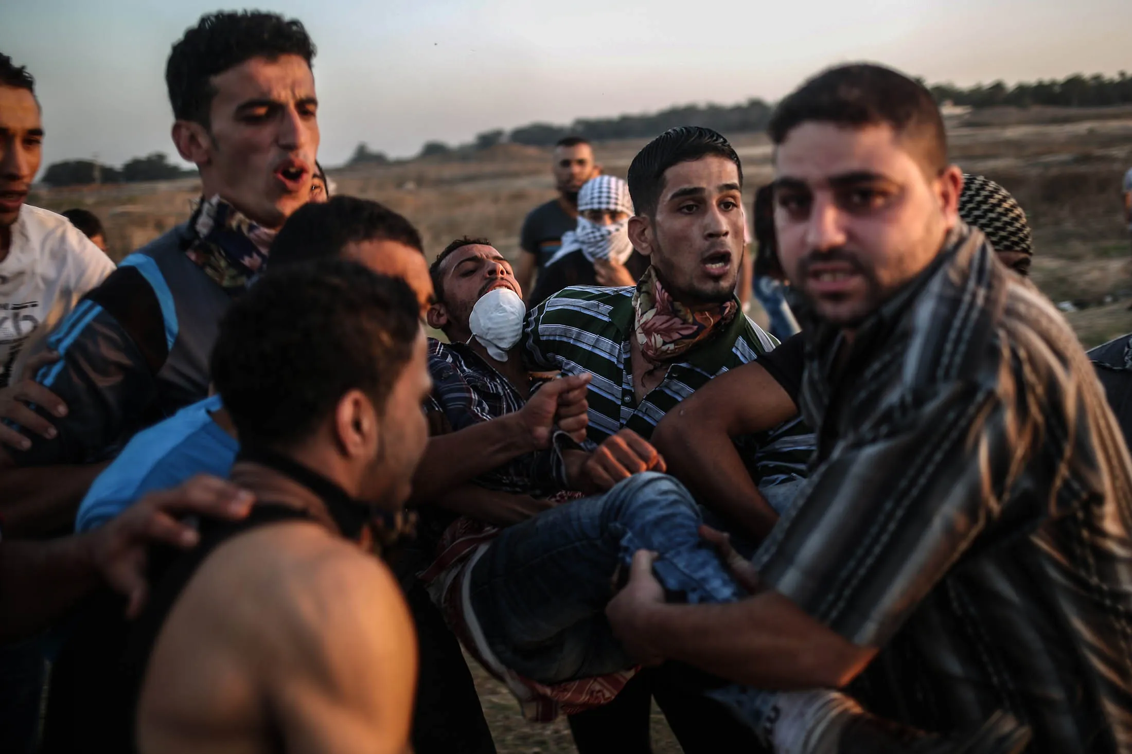 Palestinian demonstrators carry an injured protester after clashes occurred between Israeli security forces and Palestinians in Gaza on Oct. 14.

