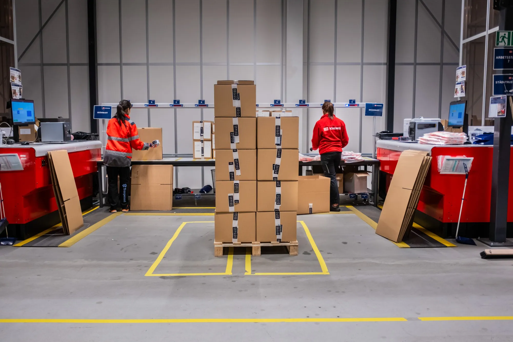 Workers pack a customers orders inside a DB Schenker logistics hub near Gothenburg, Sweden.