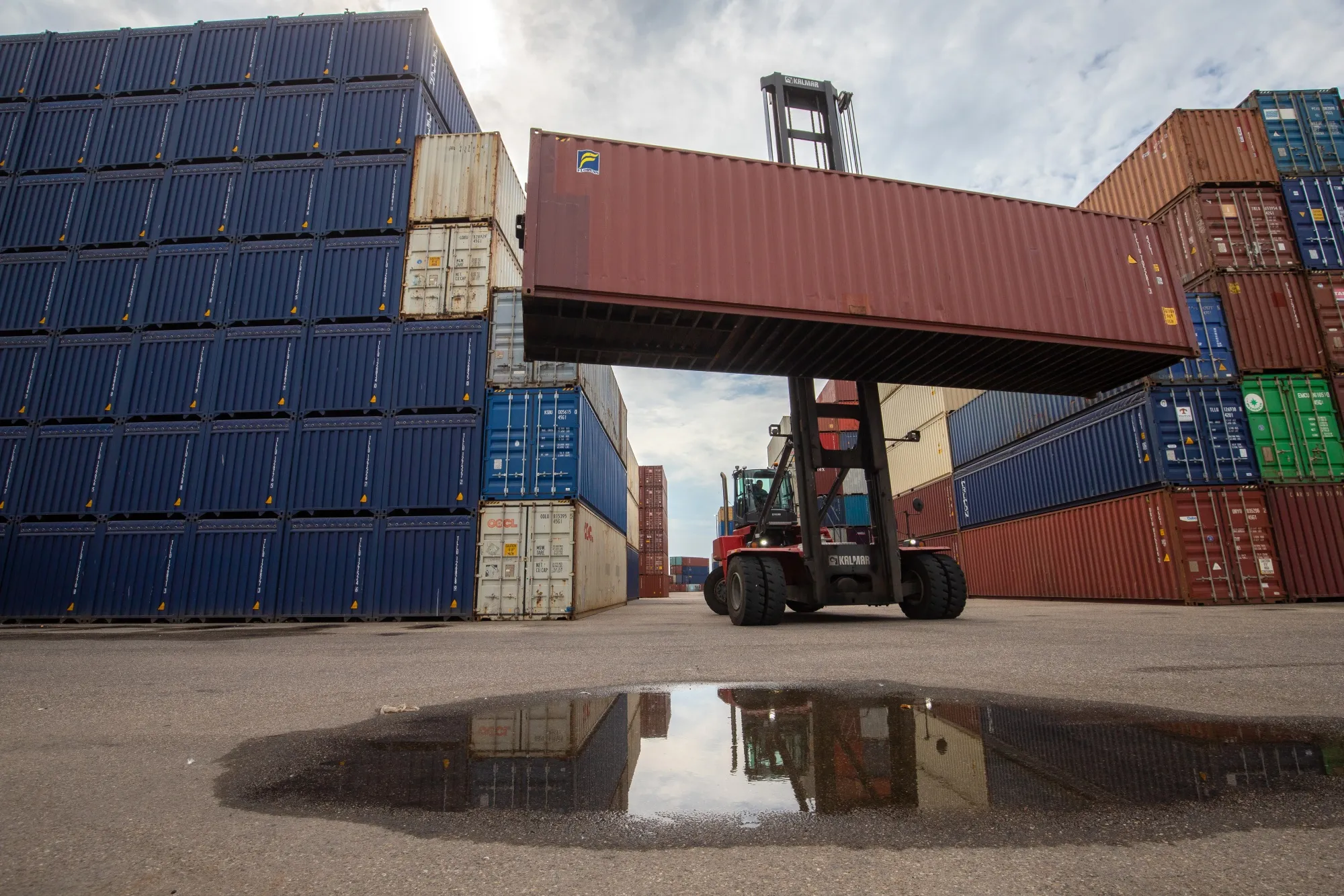 A reach stacker moves a shipping container at a container depot at the Port of Rotterdam in Rotterdam, Netherlands.