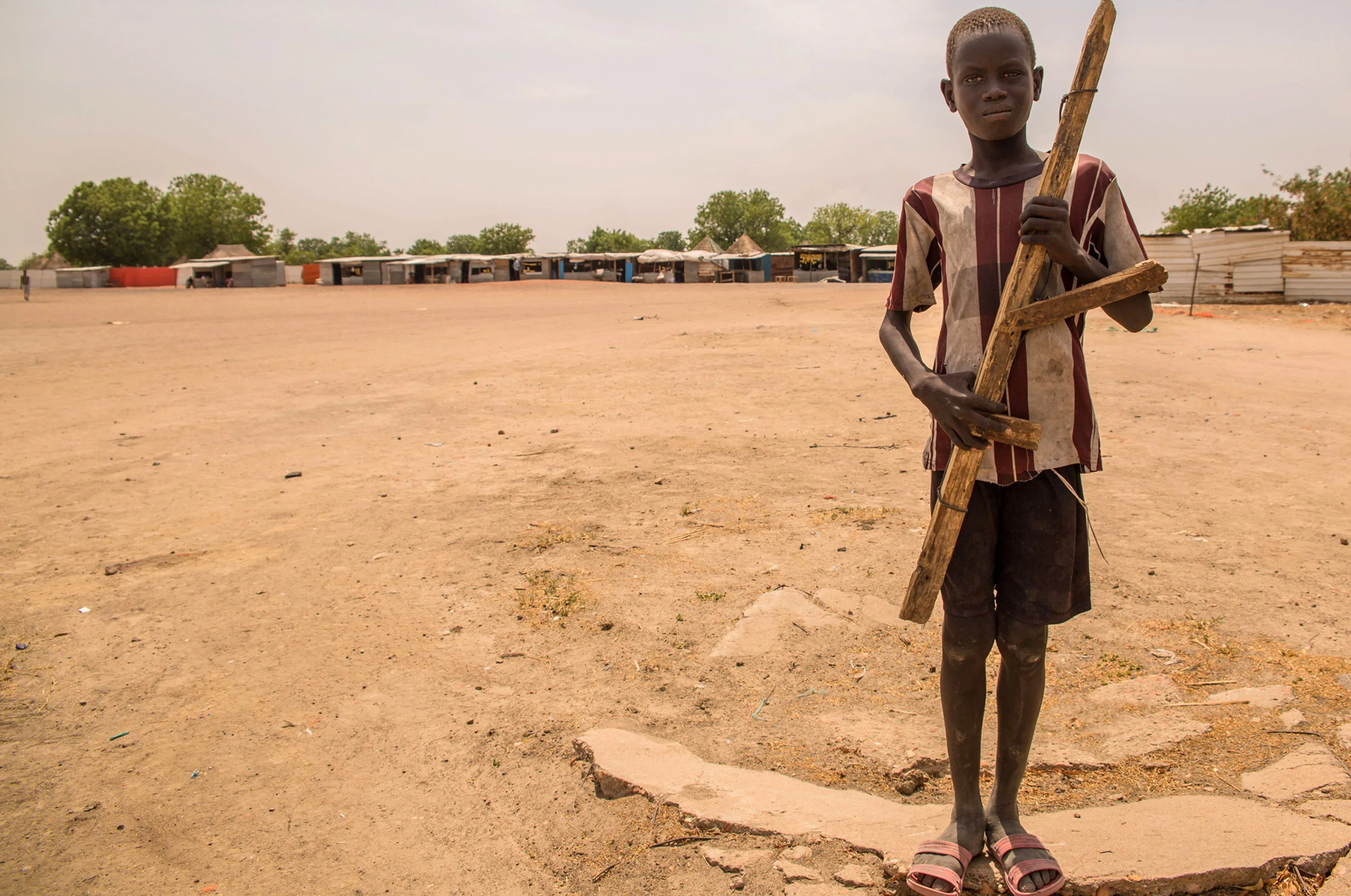 A boy poses with a wooden gun&nbsp;in Leer, South Sudan.