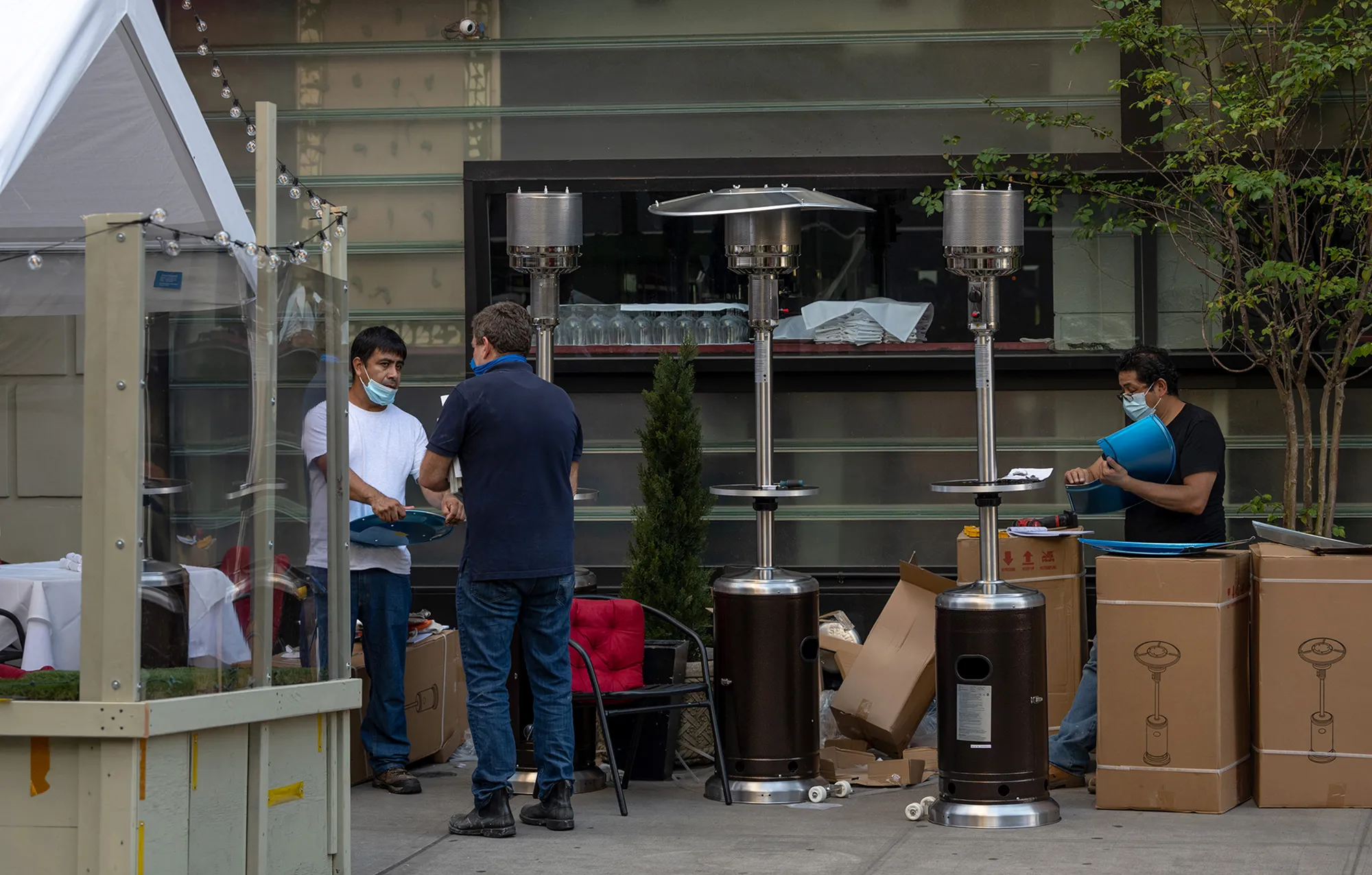 Restaurant workers set up outdoor heaters in preparation for cooler weather in New York on Sept. 28.