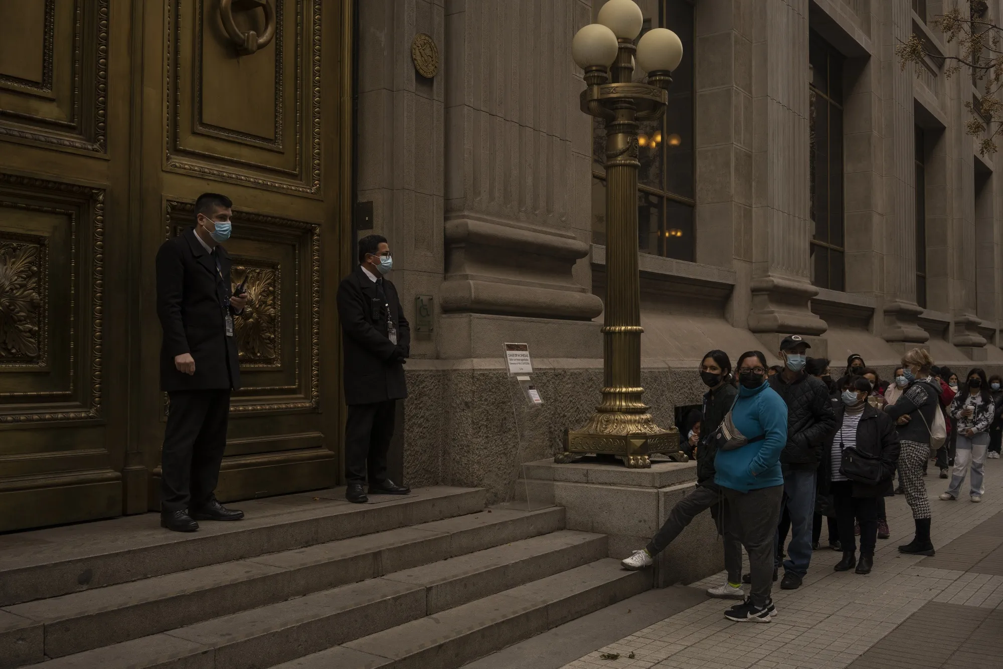 Pedestrians wait in line outside the Central Bank of Chile in Santiago on&nbsp;July 13.&nbsp;