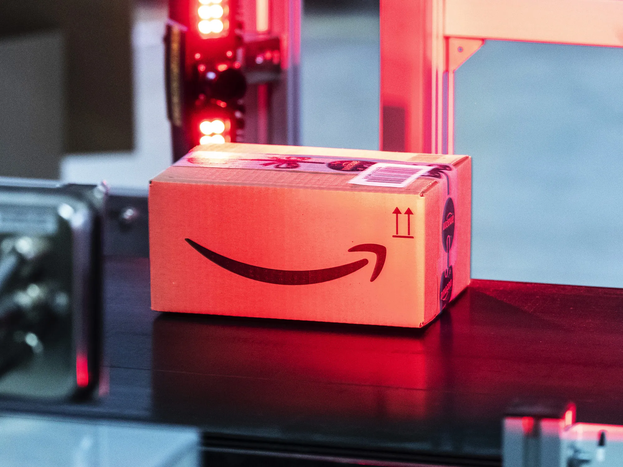 The Amazon.com Inc. logo sits on a box as it passes under a scanner inside an Amazon.com Inc. fulfilment center in Koblenz, Germany, on Friday, Nov. 23, 2018. Germans are expected to buy about 2.4 billion euros worth of goods on Black Friday and Cyber Monday, an increase of about 15 percent over last year.
