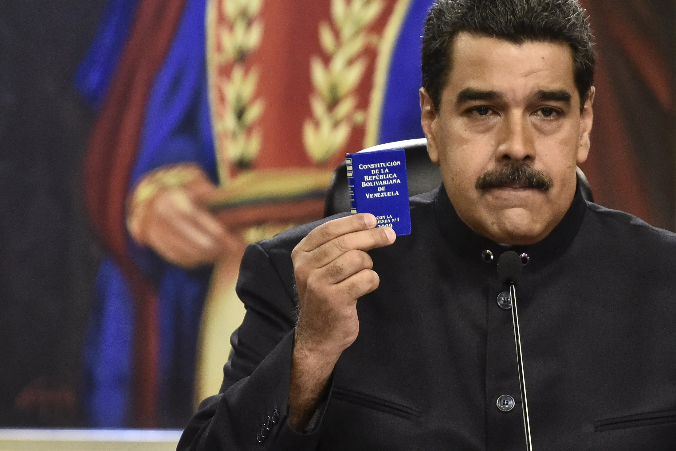 Nicolas Maduro, president of Venezuela, holds up a copy of the Venezuelan constitution during a press conference in Caracas, Venezuela, on June 22.
