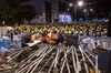 Demonstrators gather behind a barricade as they stand off against riot police during a protest in Hong Kong, China, on Monday, July 1, 2019. Riot police fired tear gas at protesters who flooded Hong Kong’s legislative building Monday evening after smashing their way through entrances in a dramatic escalation of efforts to force the government to withdraw controversial extradition legislation.