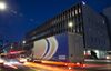 A Sagawa Express Co. truck drives past the SG Holdings Co. Tokyo offices at night in Tokyo, Japan.