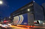 A Sagawa Express Co. truck drives past the SG Holdings Co. Tokyo offices at night in Tokyo, Japan.