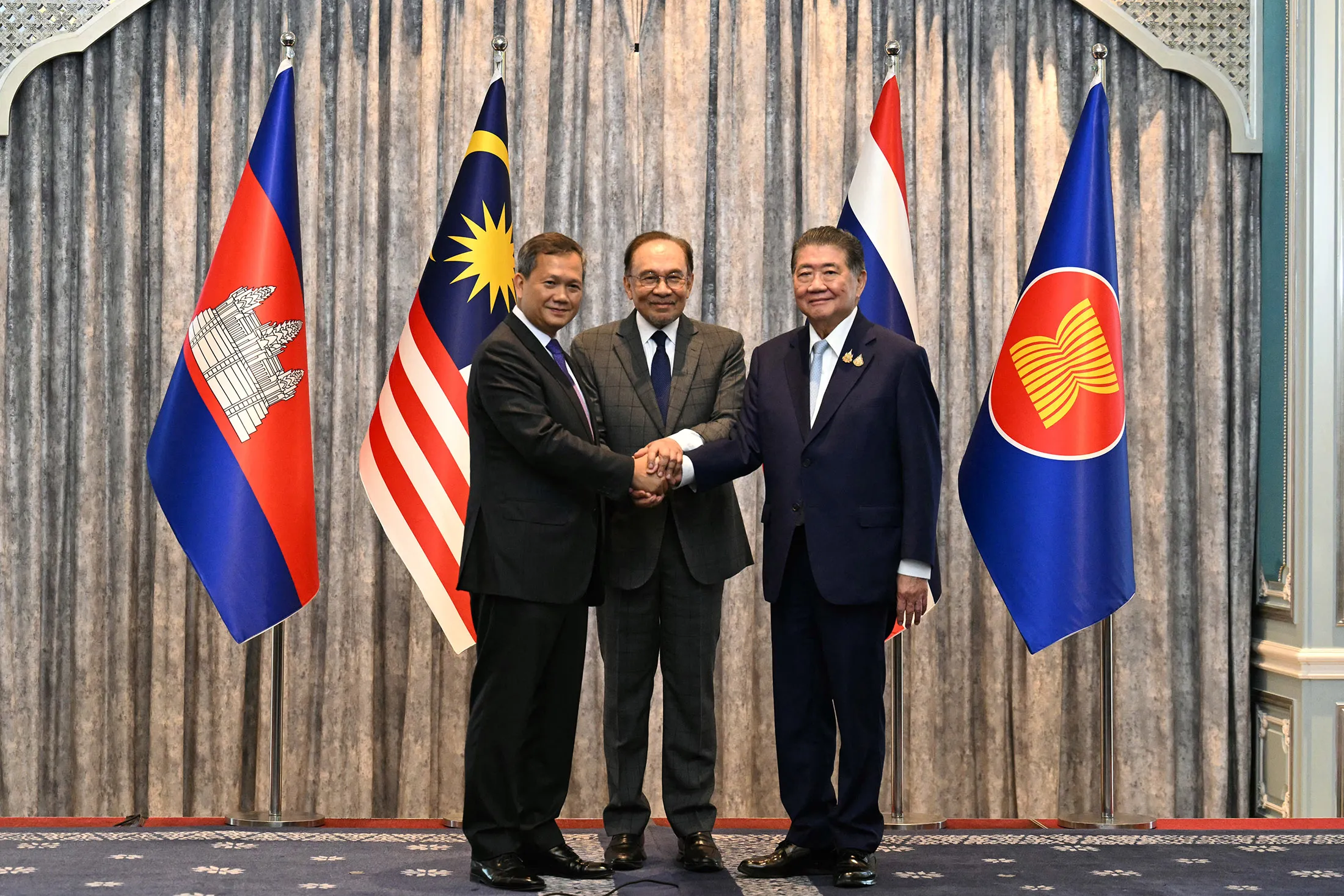 Cambodia’s&nbsp;Prime Minister Hun Manet, left, Malaysia’s Prime Minister Anwar Ibrahim, center, and Thailand’s Acting Prime Minister Phumtham Wechayachai shake hands after meeting&nbsp;in Malaysia on July 28.