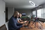 Co-hosts Dion Foxworth and Tahrim Kahlis prepare for an episode of the “Stock Market Moves” show in Johannesburg.