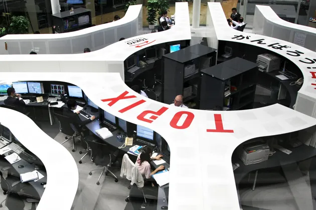 Employees work on the trading floor of the Tokyo Stock Exchange
