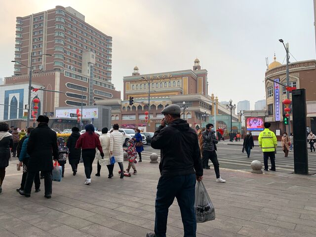 Shoppers walk past the Xinjiang International Grand Bazaar in Urumqi, capital of China’s Xinjiang province.