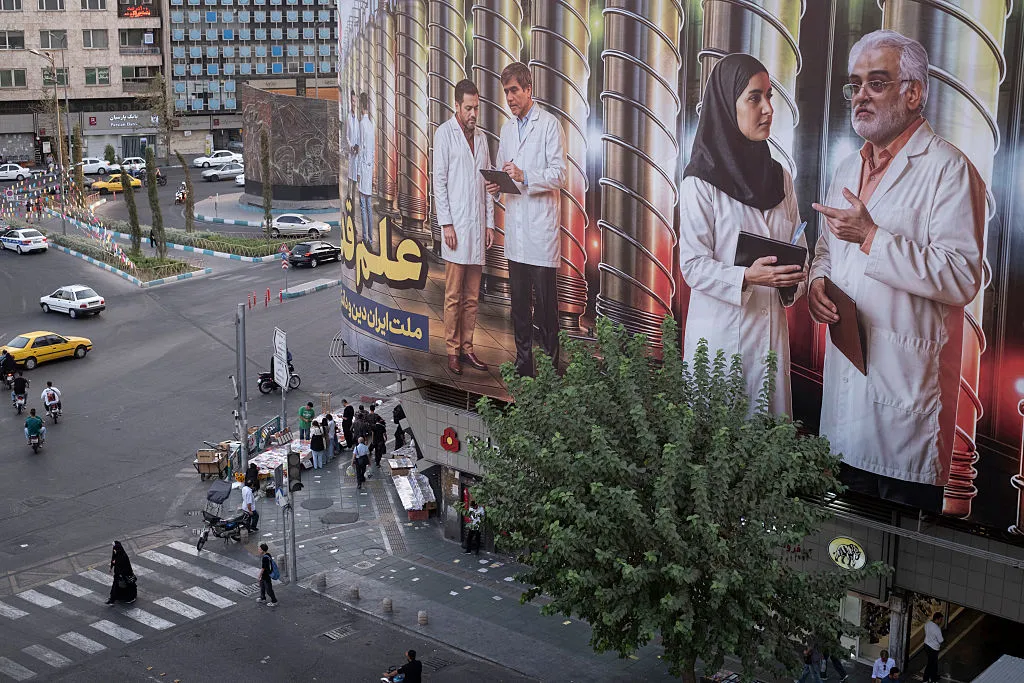A banner featuring symbolic images of Iranian nuclear scientists on a governmental building in downtown Tehran.