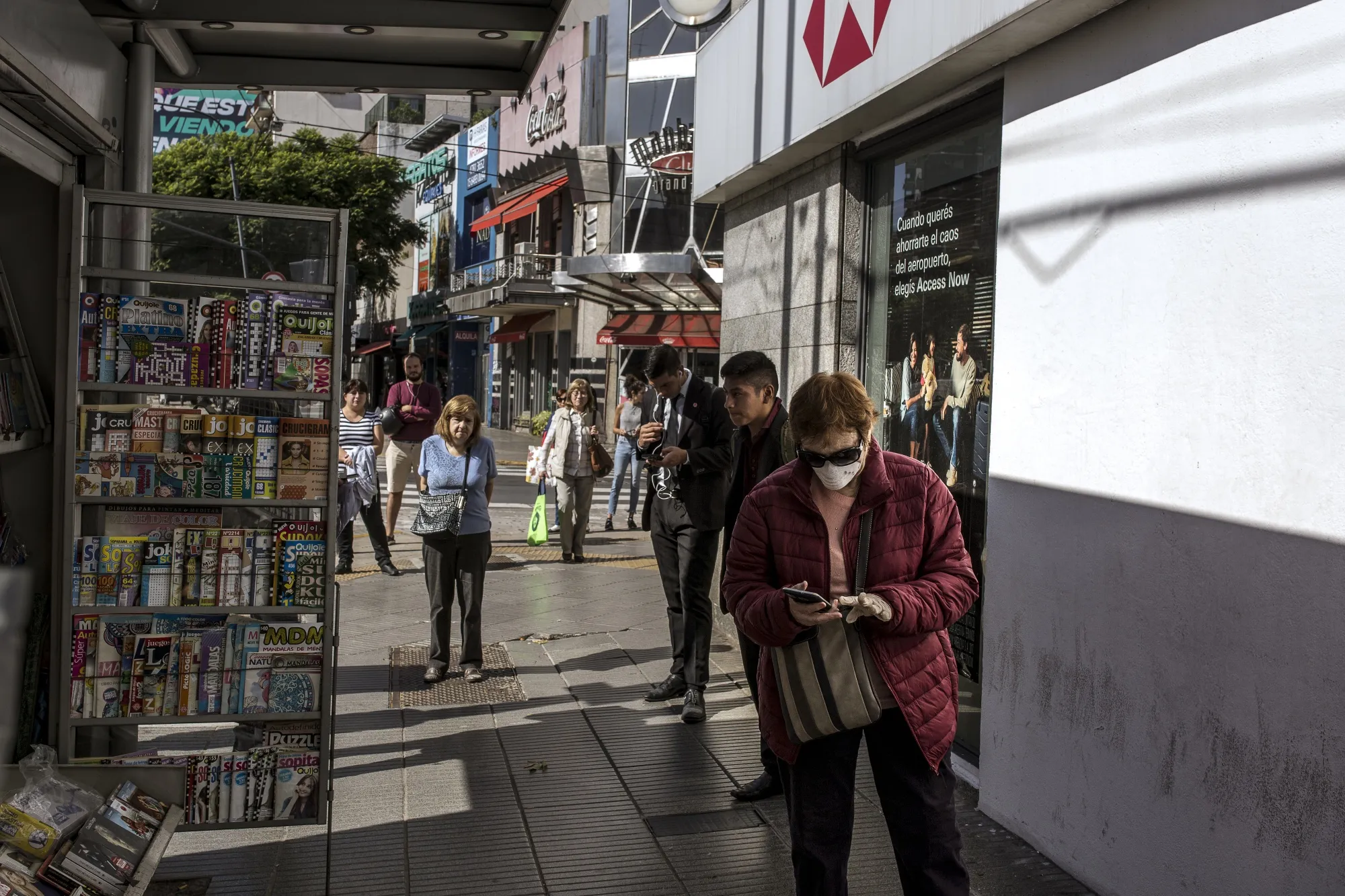 People line up&nbsp;outside banks to receive monthly cash payments, in Buenos Aires, Argentina.