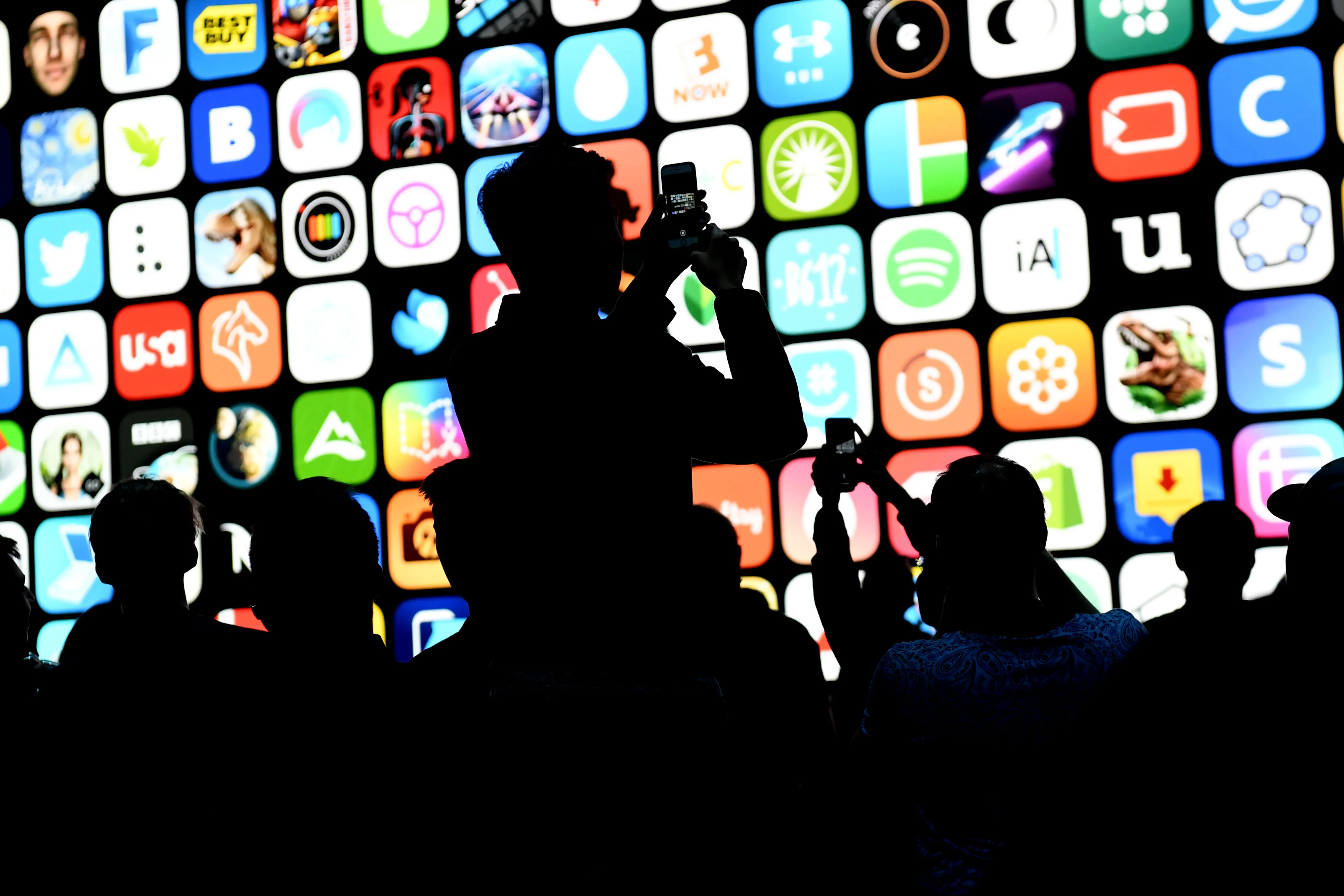 Attendees take photos before the start of the Apple Worldwide Developers Conference in San Jose, California in 2018.