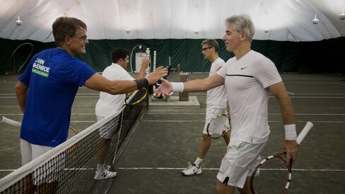 Christer Gardell and Zubin Irani shake hands with Walter Dolhare and Bill Ackman after a match in the Finance Cup