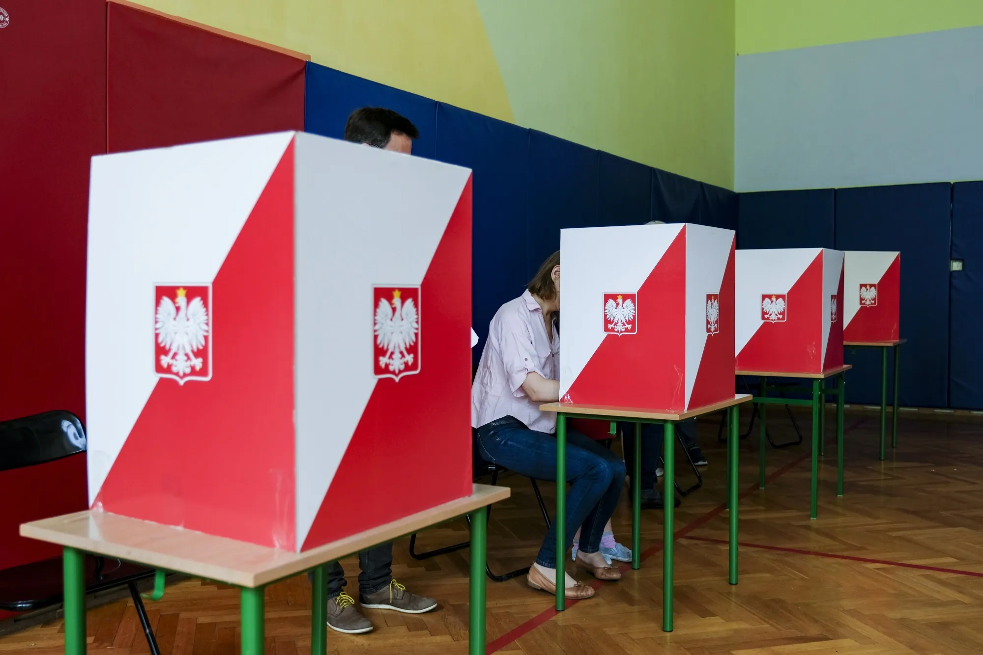 Voters mark their ballots in a polling station in Warsaw, on June 1.