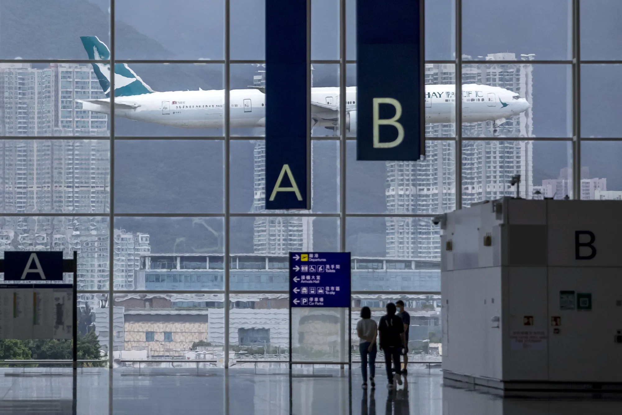 An aircraft operated by Cathay Pacific approaches Hong Kong International Airport.