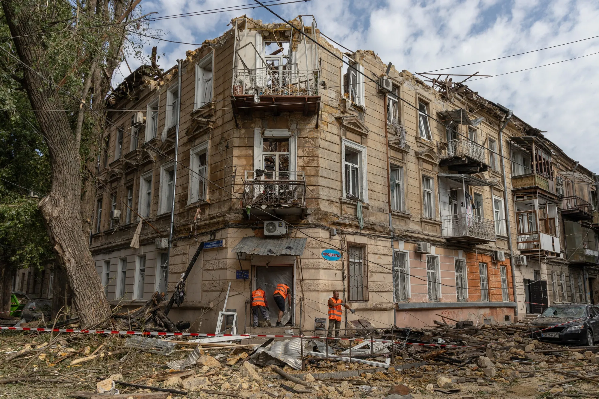 Communal workers clean debris next to a damaged residential building following a drone attack in Odesa on June 10, 2025, amid the Russian invasion in Ukraine. (Photo by Oleksandr GIMANOV / AFP) (Photo by OLEKSANDR GIMANOV/AFP via Getty Images)