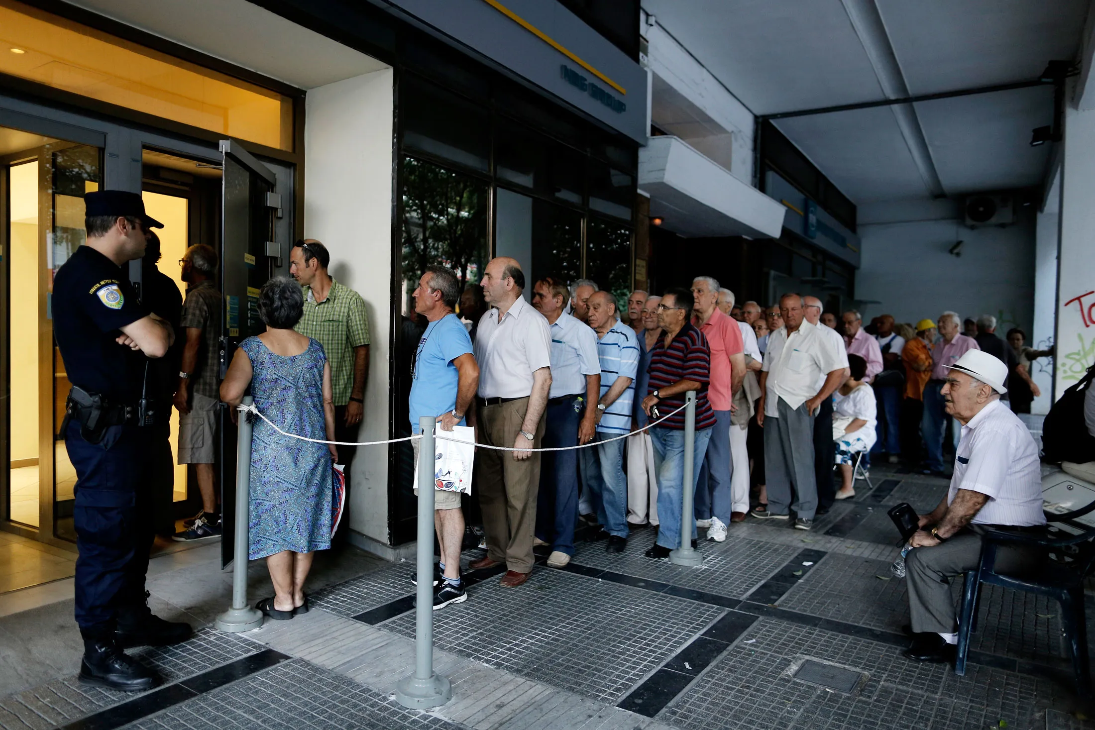Lines outside of Greek ATMs.
