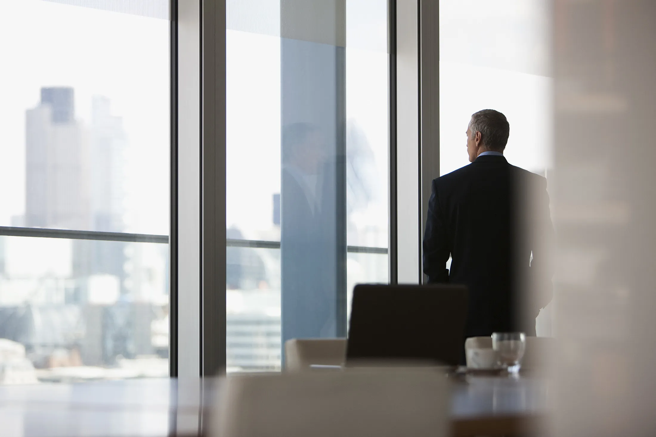 Businessman looking out conference room window