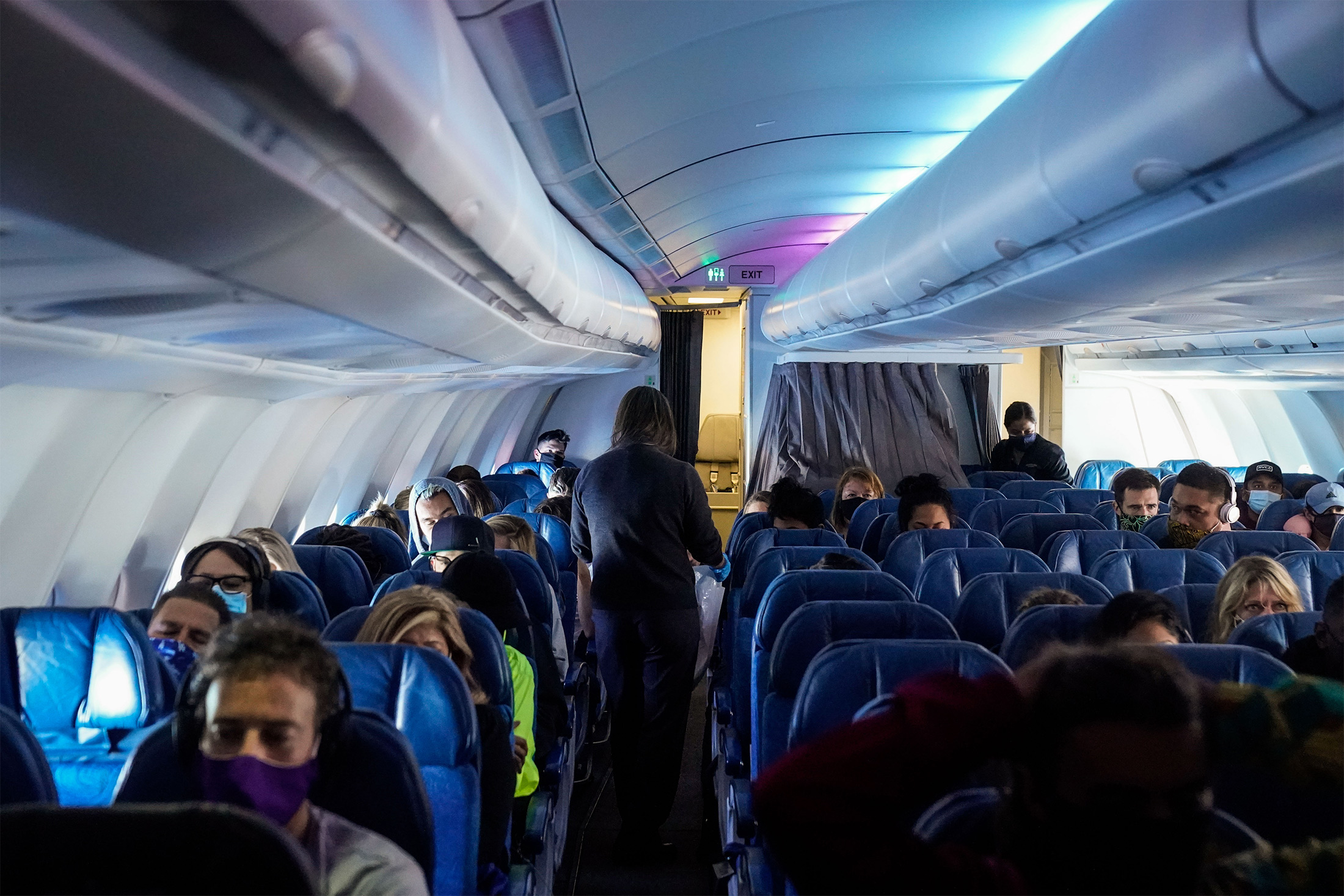 Passengers aboard a Hawaiian Airlines flight from Los Angeles to Honolulu on Oct. 15, 2020.