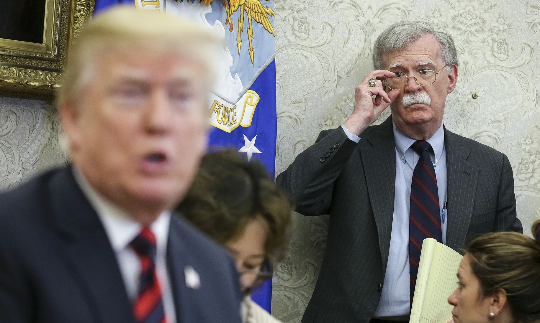John Bolton listens as Donald Trump speaks in the Oval Office of the White House on May 22, 2018.
