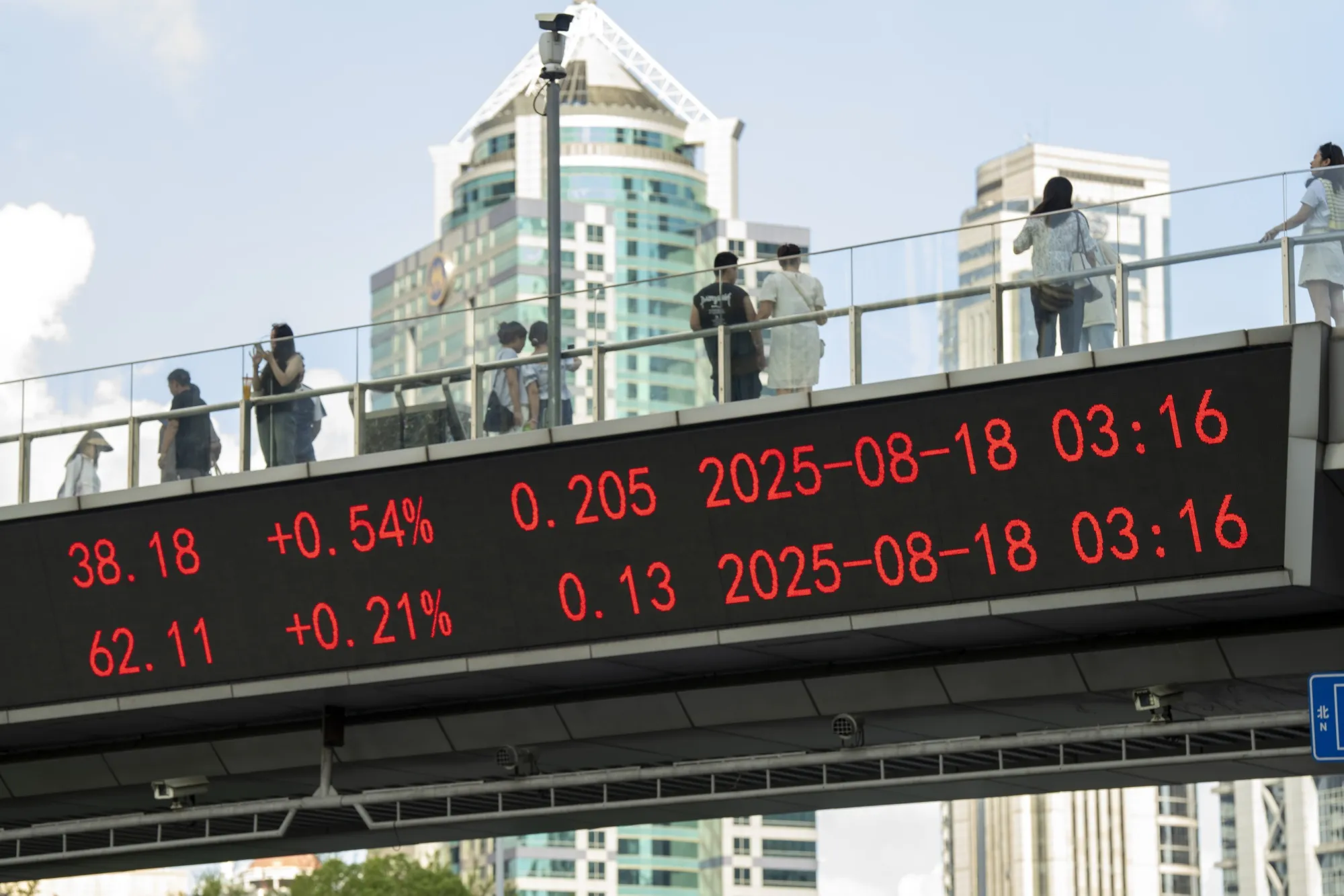 An electronic ticker displays stock prices in Shanghai’s financial district.