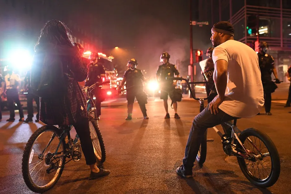 Demonstrators on their bikes face police officers outside of the White House on May 30 in Washington, D.C.