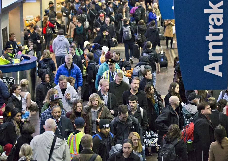 Holiday travelers scurry through Amtrak’s Union Station in Washington, D.C.