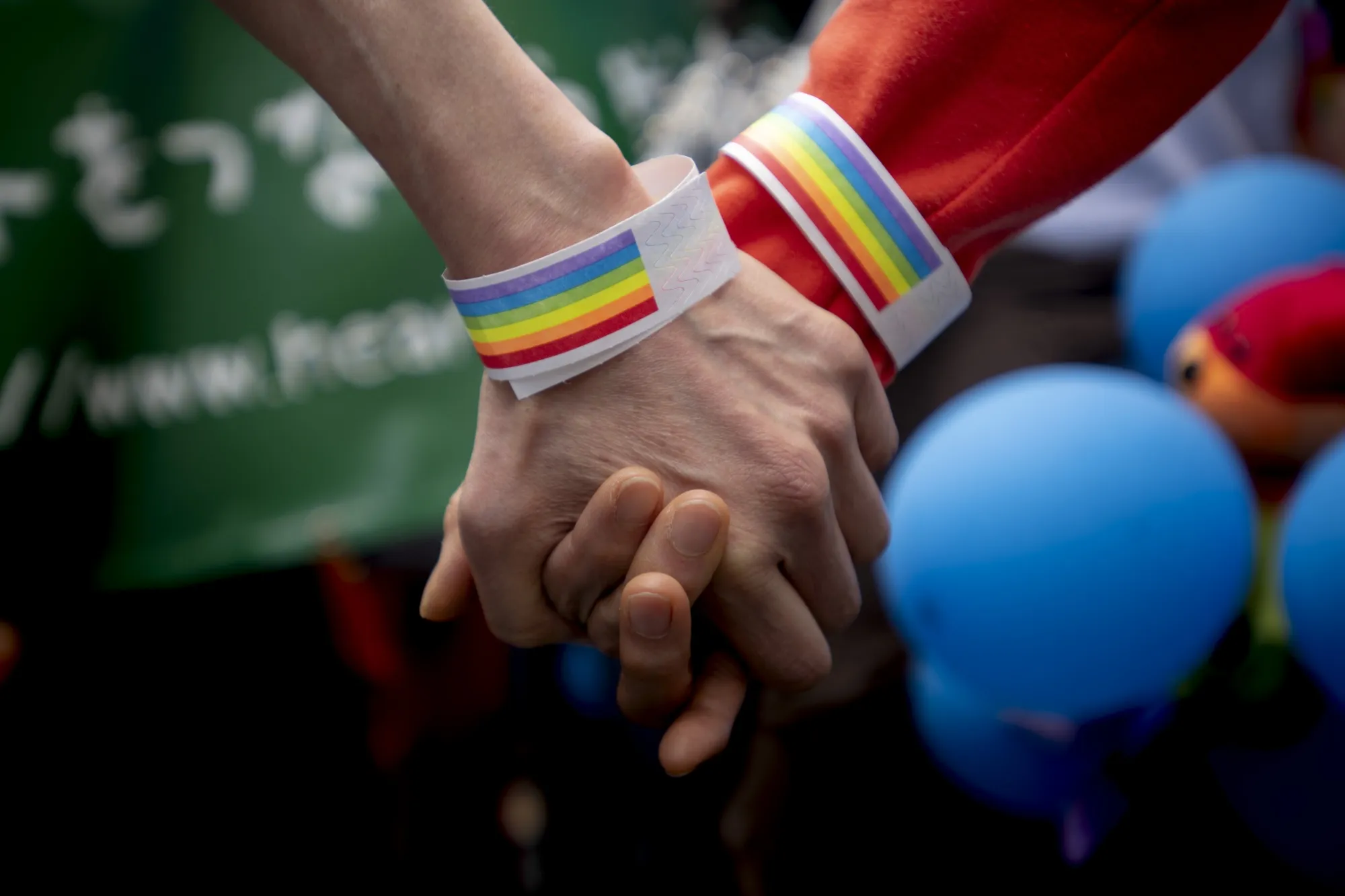 Two women hold their hands during the Pride parade on the streets of Tokyo.