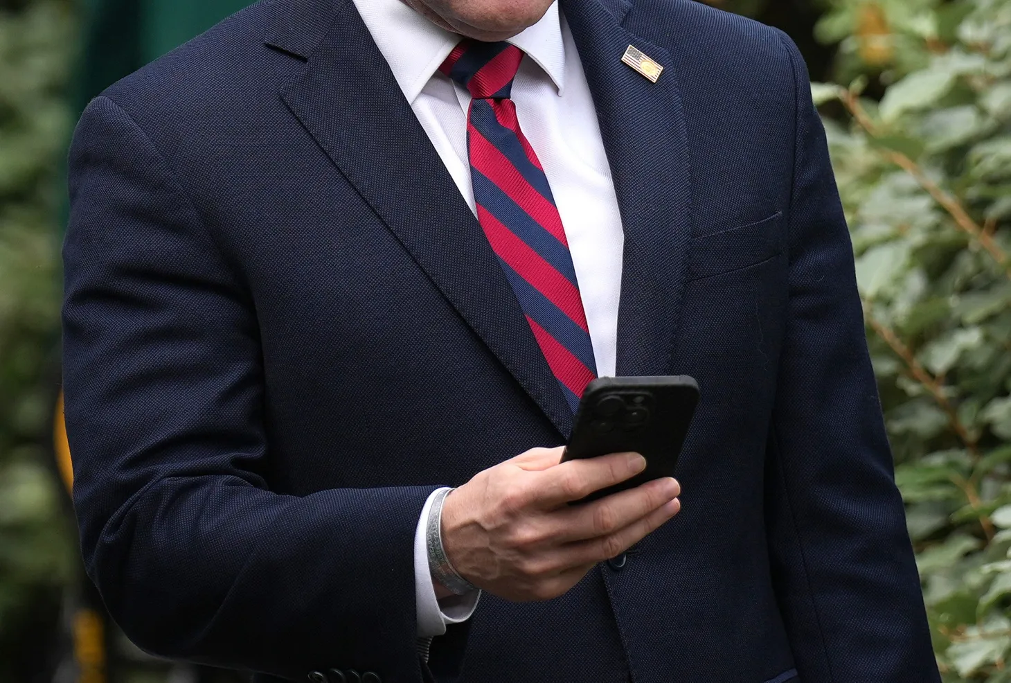 Michael Waltz looks at his phone as he prepares for a TV interview at the White House in Washington DC,&nbsp;on May 1.
