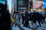 Pedestrians walk near the Nasdaq MarketSite in New York, U.S., on Friday, Jan. 21, 2022.