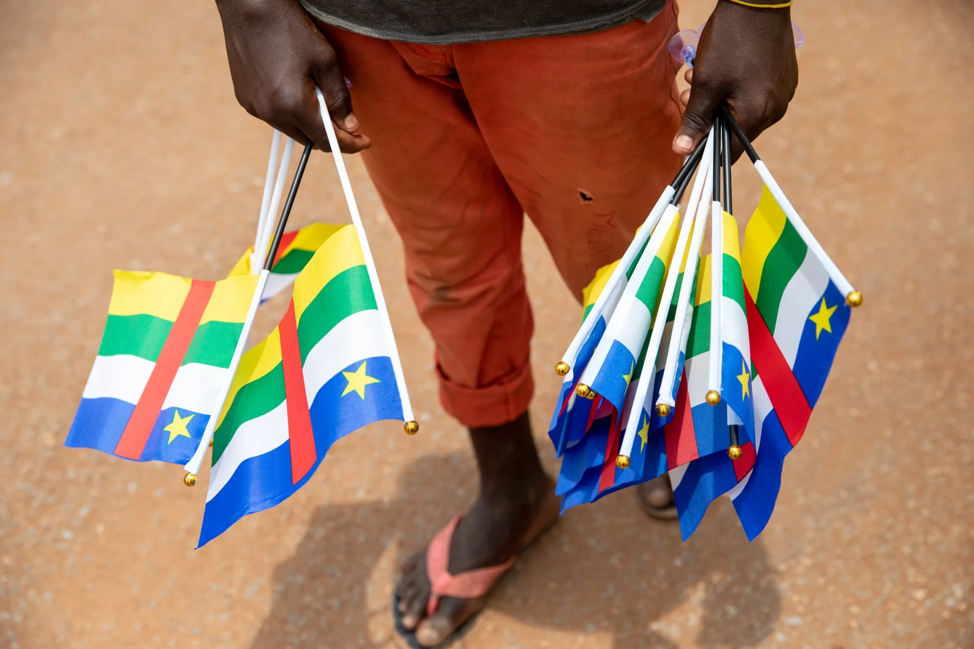 A street vendor carries&nbsp;flags of the Central African Republic for sale&nbsp;in Bangui, Central African Republic.