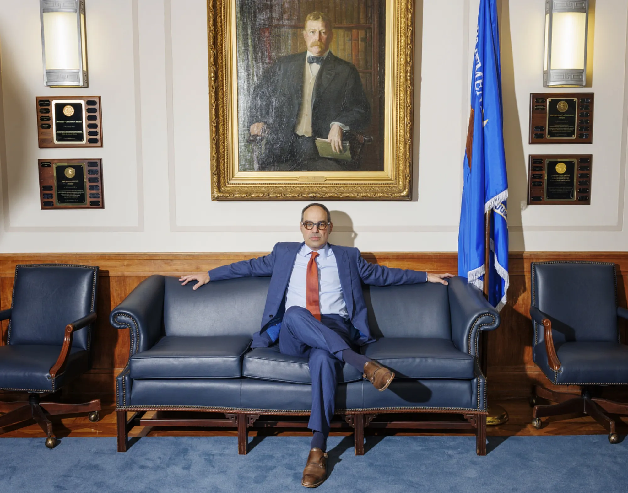 Jonathan Kanter sits in front of a portrait at Justice Department headquarters in Washington of former US Attorney General William Moody, who brought the case that led to the breakup of Standard Oil.
