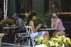People wearing protective masks sit outside a cafe in the Meatpacking neighborhood of New York, U.S., on Monday, July 6, 2020.