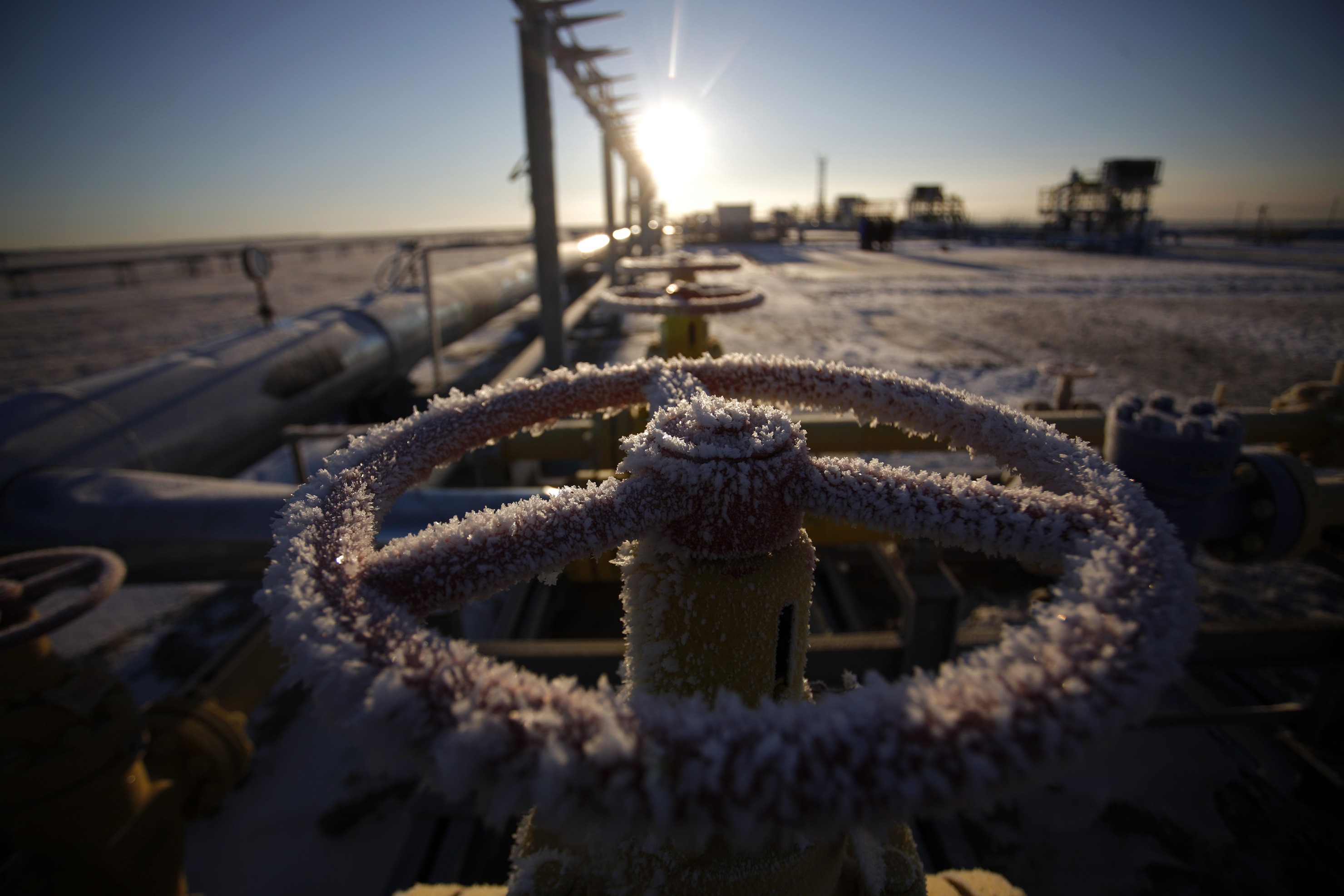 Ice sits on a valve control wheel connected to pipe work at a natural gas field in Russia.