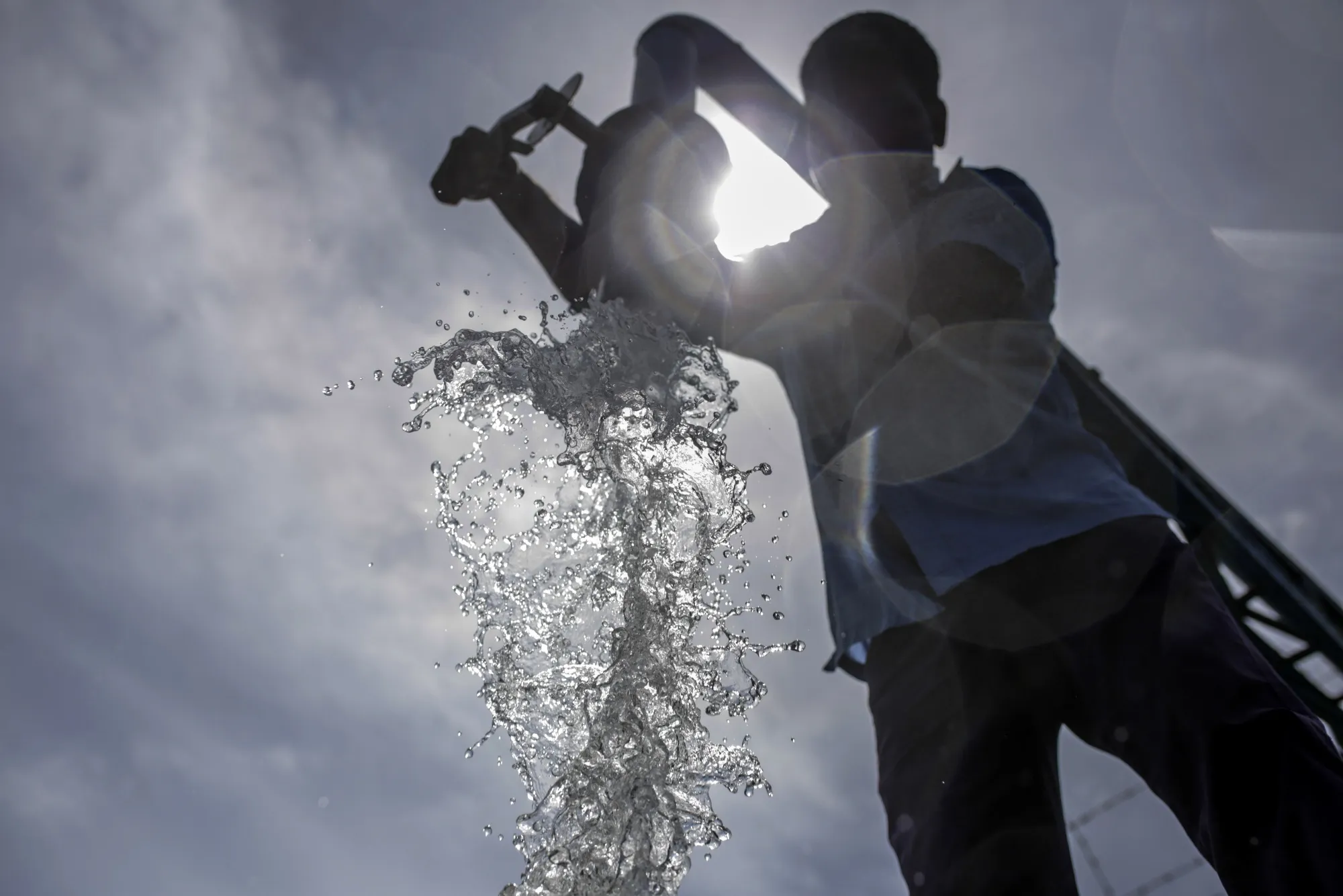 Water falls from a pipe into a&nbsp;tanker at a government run water filling station in Chennai.
