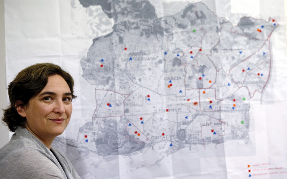 Ada Colau, &quot;Barcelona en Comu&quot; party leader and candidate for mayor of Barcelona, poses next to a city map at party headquarters.