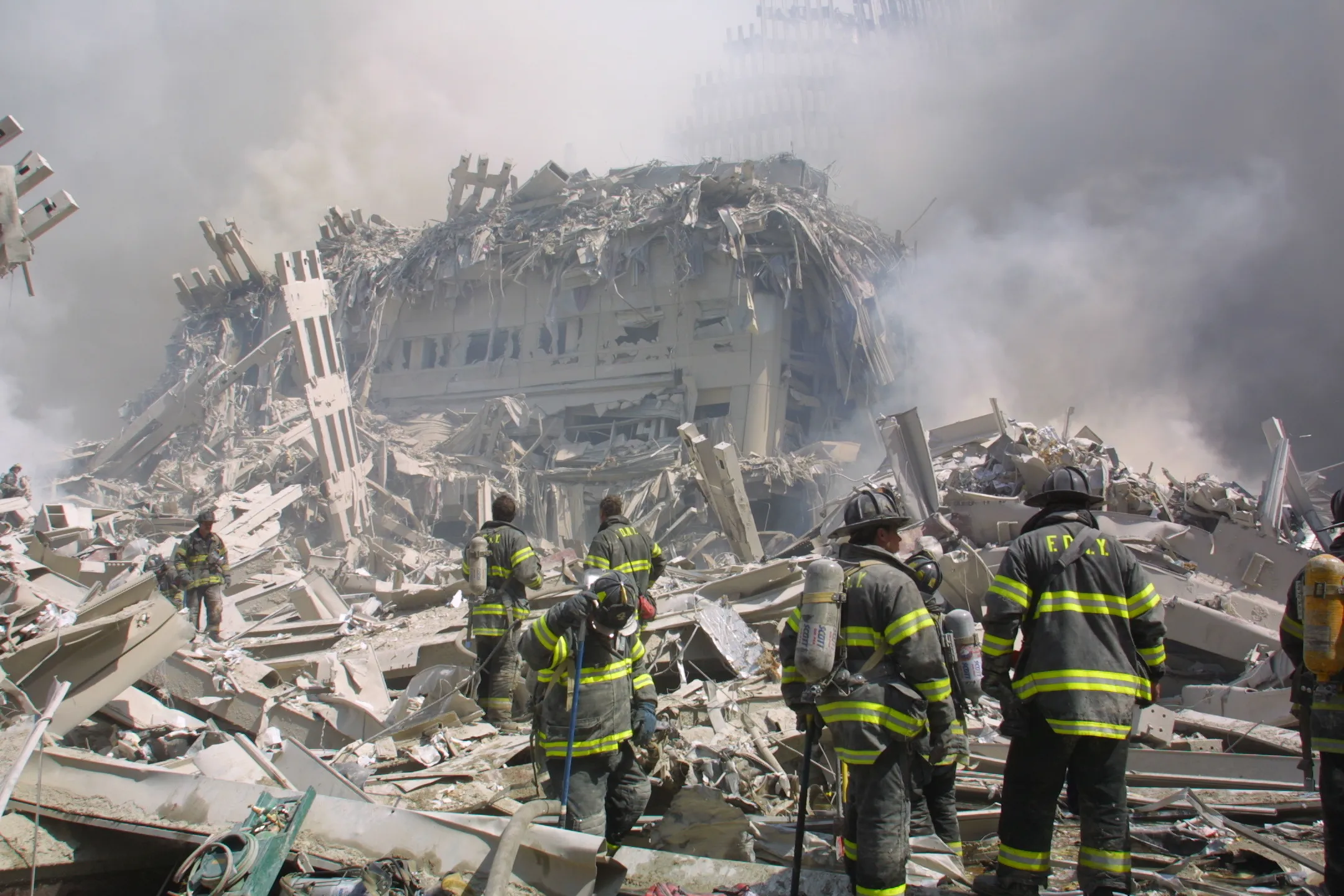 Firefighters walk through the rubble of the World Trade Center on September 11, 2001.&nbsp;