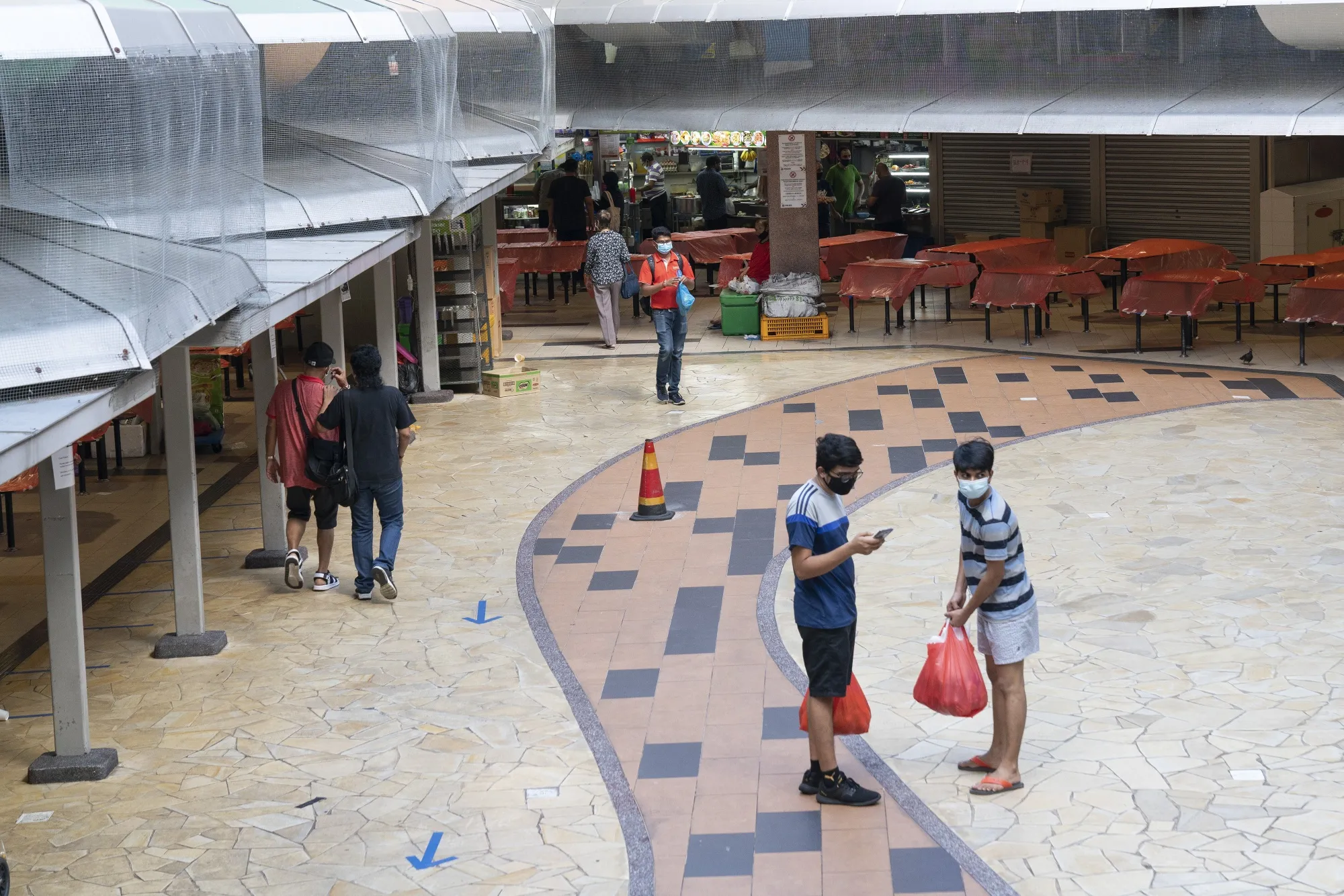 People walk through a food center in Singapore on April 20.