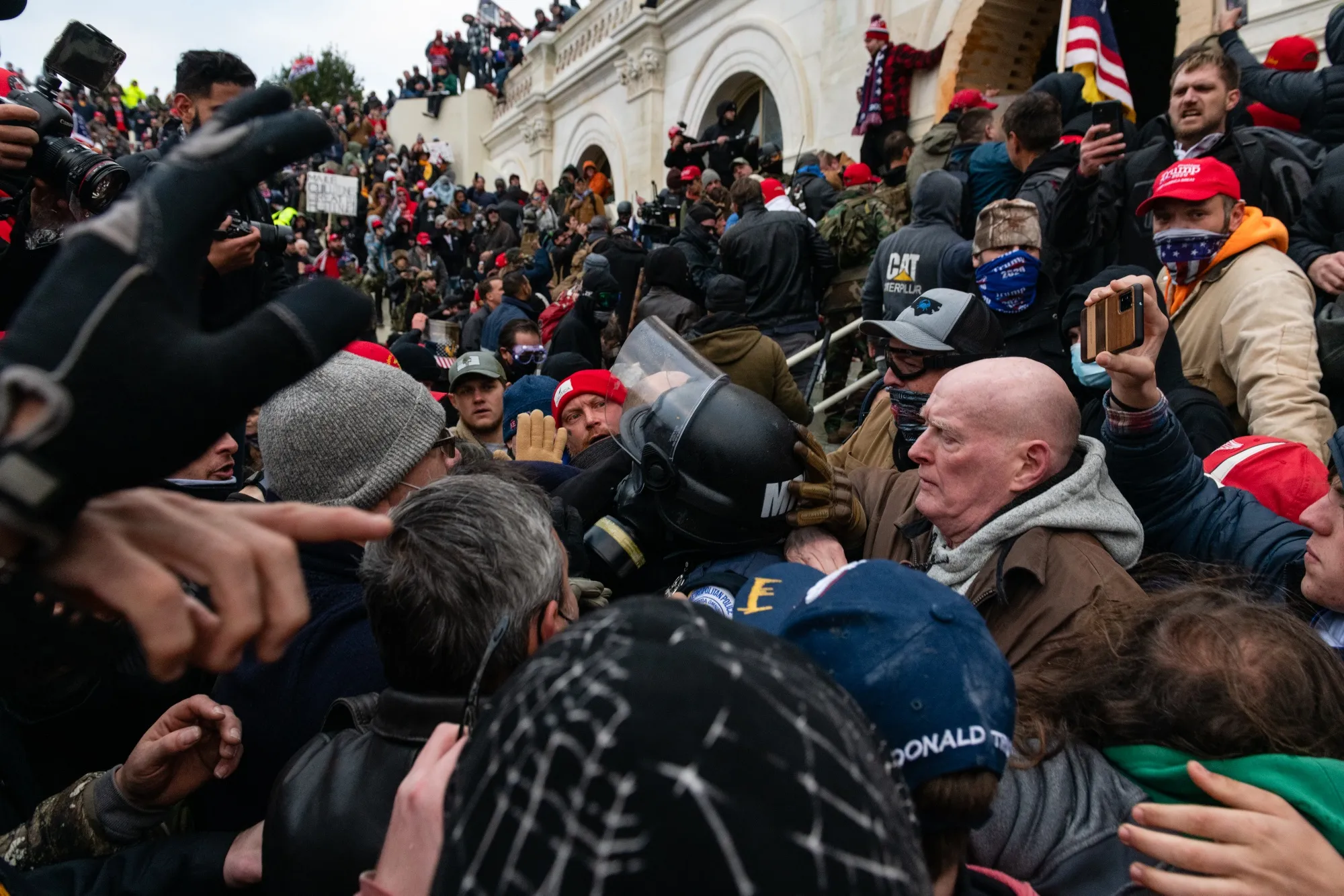 Demonstrators drag and capture a Metropolitan Police officer while attempting to enter the US Capitol in Washington on Jan. 6, 2021.