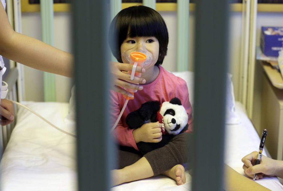 A two-year-old girl receives nebulizer treatment in Beijing in 2015.